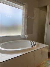 Bathroom featuring tiled bath