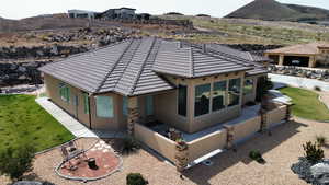 Exterior space with a patio area, a front yard, and a mountain view