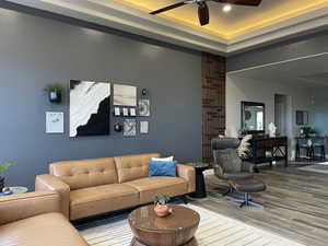 Living room featuring light wood-type flooring and ceiling fan