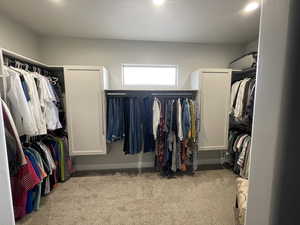 Walk in closet featuring light carpet