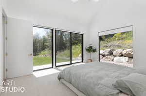 Bedroom featuring high vaulted ceiling, carpet floors, and access to outside