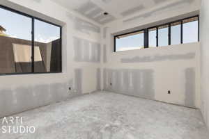 Unfurnished room with concrete flooring