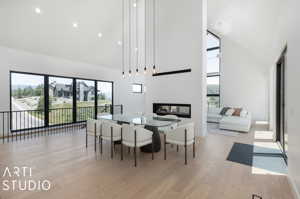 Dining room with high vaulted ceiling and light wood-type flooring