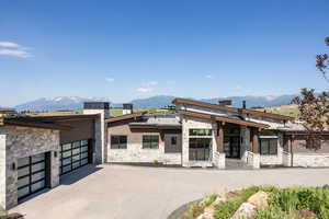 View of front of property featuring a mountain view and a garage