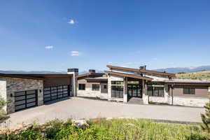 Exterior space with a garage and a mountain view