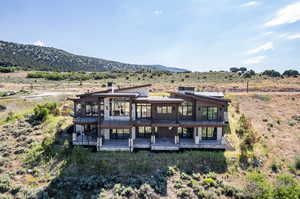 Back of property featuring a mountain view