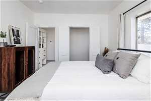 one of two bedrooms on the main floor. With view of closet doors open and window.
