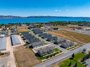 Birds eye view of property with a water and mountain view