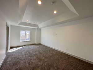 Master bedroom featuring a raised ceiling
