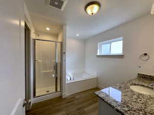Master Bathroom LVP floors, independent shower and bath, and vanity