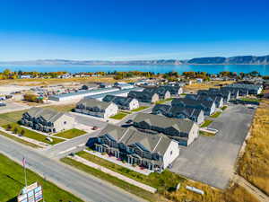 Birds eye view of property featuring a water and mountain view