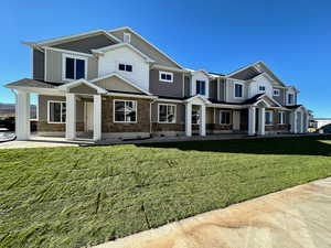 View of front of house featuring a front lawn and covered porch