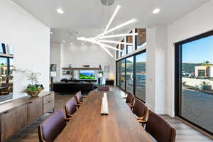 Dining room with dark wood-type flooring and a high ceiling