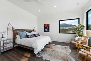 Bedroom featuring ceiling fan and dark wood-type flooring