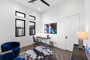 Home office featuring ceiling fan and dark hardwood / wood-style floors