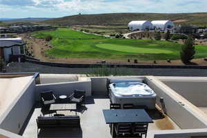 Exterior space featuring a hot tub and an outdoor hangout area