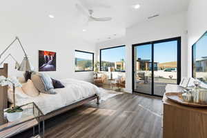 Bedroom featuring ceiling fan, access to outside, and dark wood-type flooring