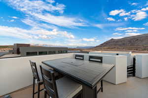 View of patio featuring a mountain view and a balcony