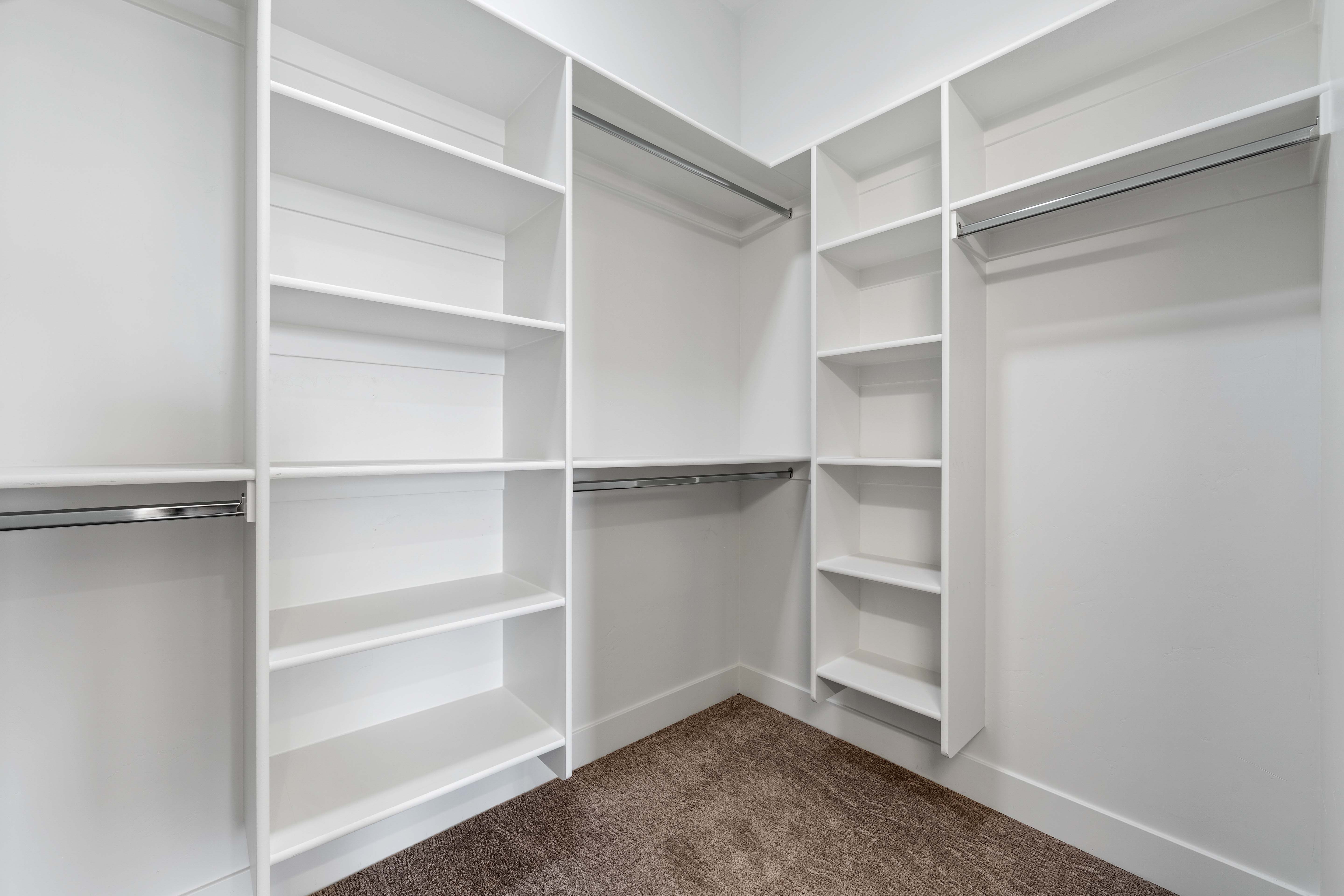 Walk in closet with dark carpet