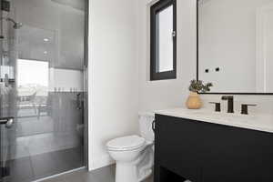 Bathroom with a shower with door, oversized vanity, and toilet