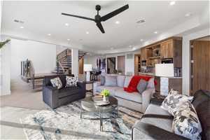 Tiled living room featuring ceiling fan and a tray ceiling