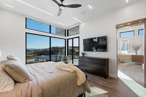 Bedroom with ceiling fan and dark hardwood / wood-style floors