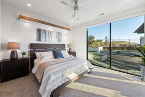 Bedroom with ceiling fan, access to exterior, and dark colored carpet