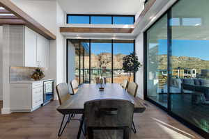 Dining room with a mountain view, dark hardwood / wood-style floors, and beverage cooler