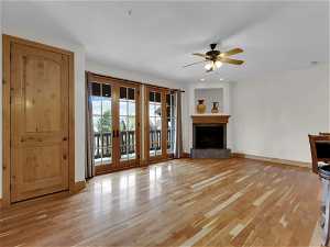 Unfurnished living room featuring french doors, light hardwood / wood-style flooring, and ceiling fan