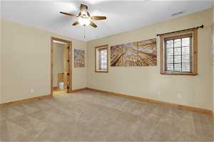 Unfurnished 1st bedroom featuring ceiling fan