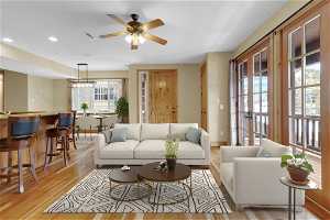 Living room featuring light hardwood / wood-style floors, ceiling fan, informal dining