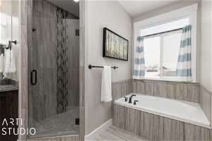 Bathroom with a wealth of natural light, vanity, tile floors, and shower with separate bathtub