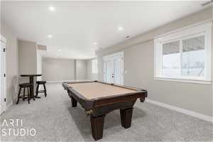 Playroom with pool table and light colored carpet