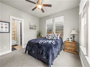 Master Bedroom with ensuite bath, ceiling fan, and light-colored carpet