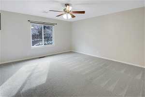 Carpeted primary bedroom with ceiling fan, great mountain views and large closets