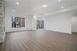 Unfurnished living room featuring dark hardwood / wood-style flooring