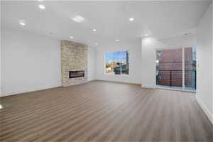 Unfurnished living room with a fireplace and hardwood / wood-style floors