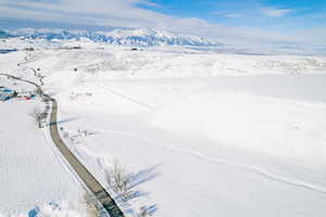 Snowy aerial view featuring a mountain view