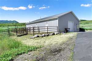 View of side of property featuring a barn with four walkout stalls