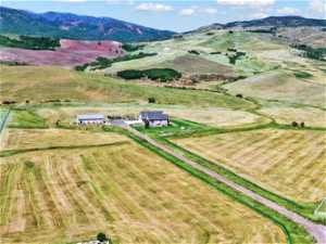 Bird's eye view with a rural view and a view of home, barn and surrounding pastures