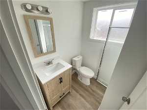 Bathroom featuring vanity, toilet, and LVP wood-style floors