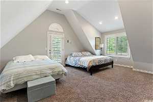 Carpeted bedroom featuring access to outside and lofted ceiling