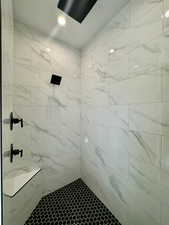 Bathroom featuring tiled shower