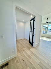 Unfurnished room featuring a textured ceiling, ceiling fan, and light hardwood / wood-style flooring