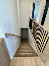 Staircase with hardwood / wood-style floors