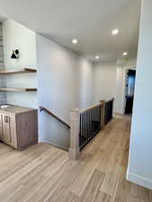 Hall featuring light wood-type flooring and a textured ceiling