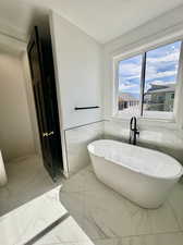 Bathroom featuring tile walls and a washtub