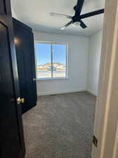 Spare room with ceiling fan, a textured ceiling, and carpet flooring