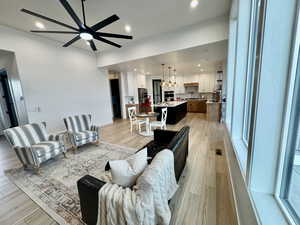 Living room featuring plenty of natural light, ceiling fan, and light hardwood / wood-style flooring