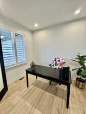 Home office with light wood-type flooring